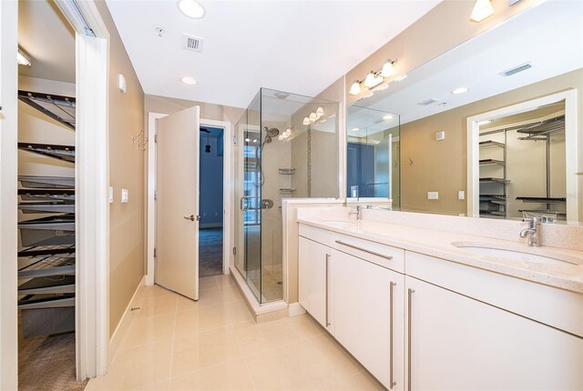 260 S Osceola Ave Unit 710, Orlando, FL 32801 - full bath with a spacious closet, double vanity, a stall shower, tile patterned floors, and recessed lighting