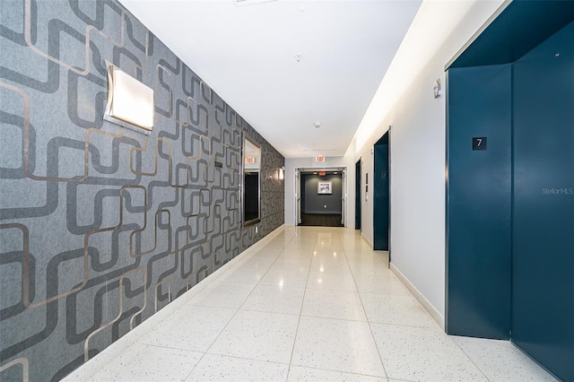 260 S Osceola Ave Unit 710, Orlando, FL 32801 - hall featuring elevator, wallpapered walls, and an accent wall