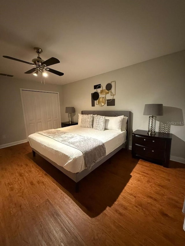 8894 Candy Palm Rd, Kissimmee, FL 34747 - bedroom with wood finished floors, baseboards, a closet, and ceiling fan