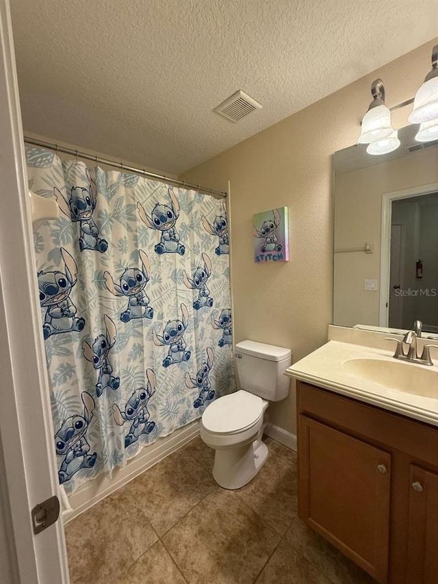 8894 Candy Palm Rd, Kissimmee, FL 34747 - bathroom with vanity, toilet, a textured ceiling, tile patterned flooring, and shower / bathtub combination with curtain