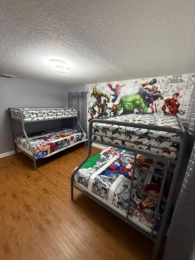 8894 Candy Palm Rd, Kissimmee, FL 34747 - bedroom with wood finished floors and a textured ceiling