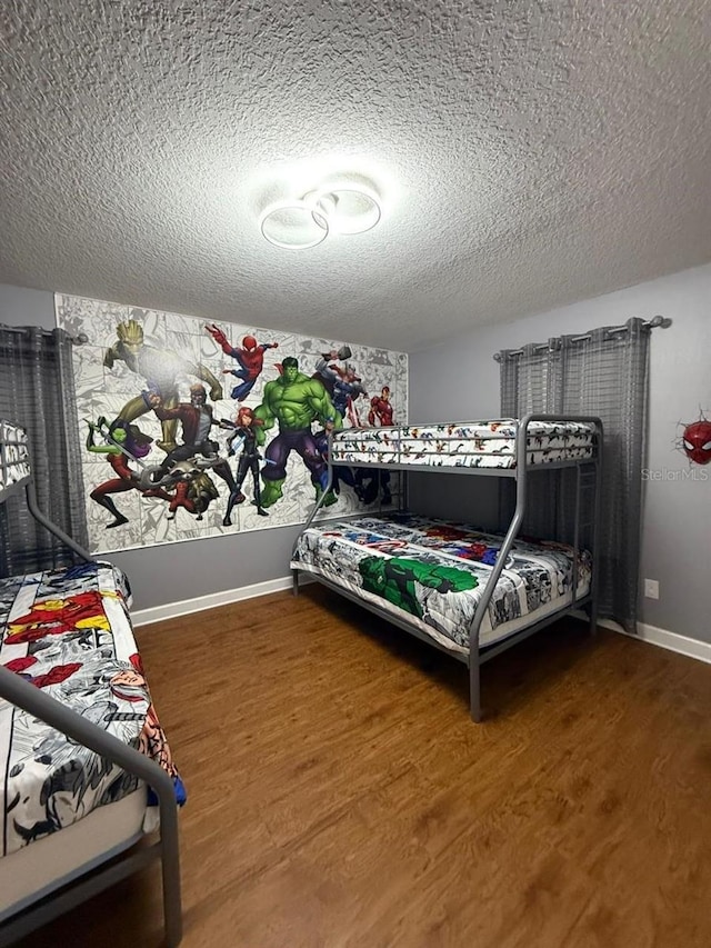 8894 Candy Palm Rd, Kissimmee, FL 34747 - bedroom featuring a textured ceiling, wood finished floors, and baseboards