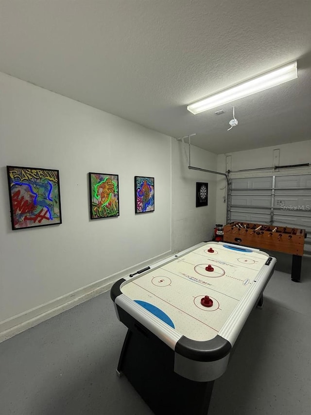 8894 Candy Palm Rd, Kissimmee, FL 34747 - game room with a garage, concrete floors, and a textured ceiling