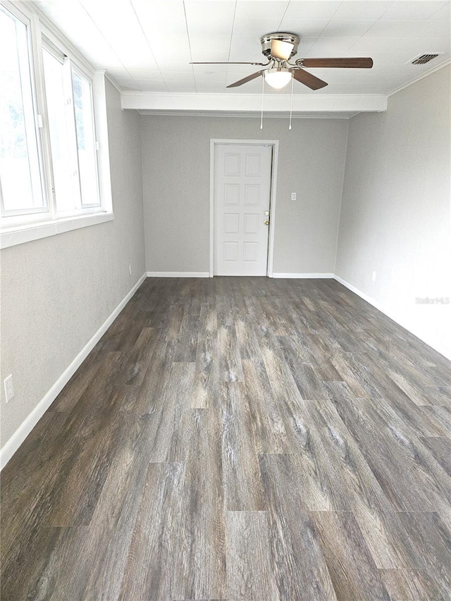 empty room featuring a ceiling fan, wood finished floors, and baseboards