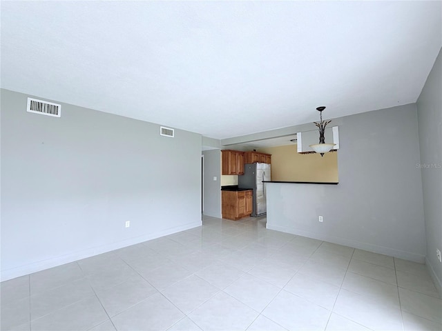 250 N Banana River Dr Unit H11, Merritt Island, FL 32952 - unfurnished living room featuring baseboards and light tile patterned floors