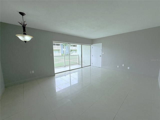 250 N Banana River Dr Unit H11, Merritt Island, FL 32952 - empty room featuring baseboards and light tile patterned flooring