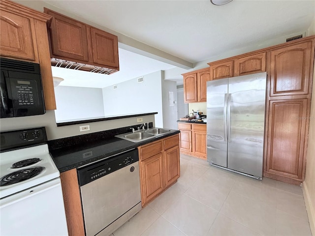 250 N Banana River Dr Unit H11, Merritt Island, FL 32952 - kitchen with stainless steel appliances, a sink, dark countertops, and light tile patterned floors