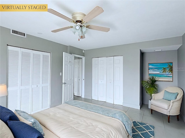 250 N Banana River Dr Unit H11, Merritt Island, FL 32952 - bedroom featuring tile patterned floors, two closets, and ceiling fan