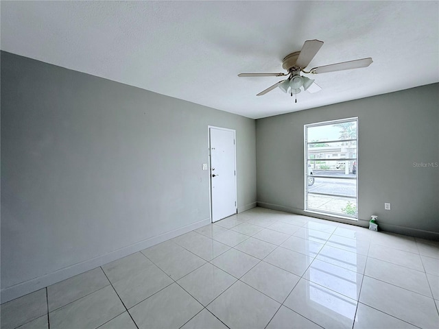 250 N Banana River Dr Unit H11, Merritt Island, FL 32952 - empty room with ceiling fan, light tile patterned floors, and baseboards