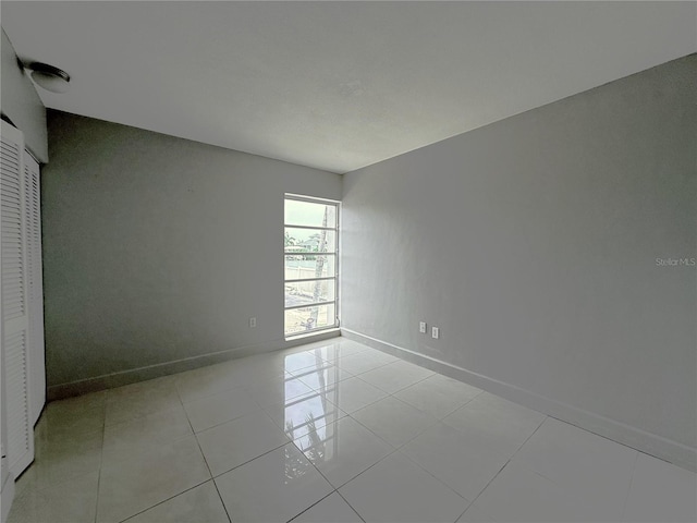 250 N Banana River Dr Unit H11, Merritt Island, FL 32952 - spare room featuring baseboards and light tile patterned floors