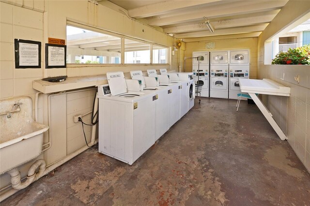 250 N Banana River Dr Unit H11, Merritt Island, FL 32952 - community laundry room featuring stacked washing machine and dryer and washing machine and dryer