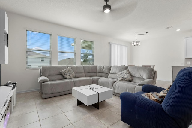 884 Laurel View Way, Groveland, FL 34736 - living area featuring light tile patterned floors, ceiling fan, baseboards, and a chandelier