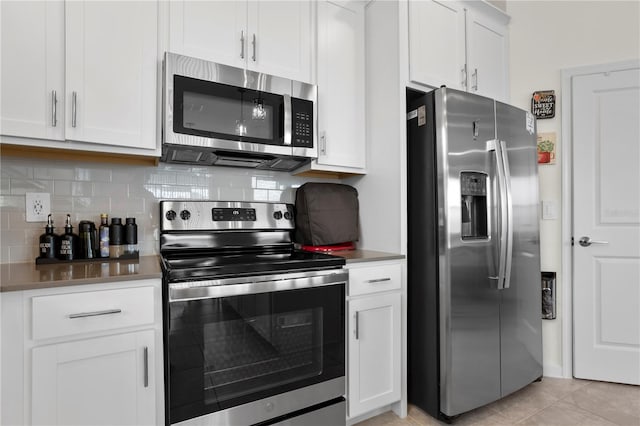 884 Laurel View Way, Groveland, FL 34736 - kitchen with appliances with stainless steel finishes, tasteful backsplash, and white cabinetry