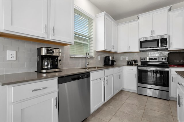 884 Laurel View Way, Groveland, FL 34736 - kitchen with appliances with stainless steel finishes, a sink, white cabinetry, and tasteful backsplash