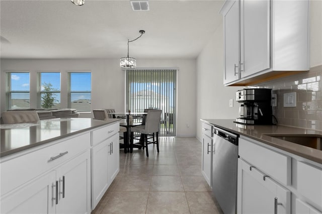 884 Laurel View Way, Groveland, FL 34736 - kitchen with dishwasher, tasteful backsplash, white cabinets, hanging light fixtures, and light tile patterned floors