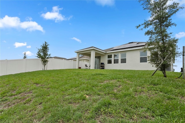 884 Laurel View Way, Groveland, FL 34736 - back of property featuring roof mounted solar panels and stucco siding