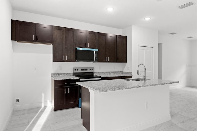 104 W Gondolier Pl, Citrus Springs, FL 34434 - kitchen featuring stainless steel microwave, light marble finish floors, electric stove, an island with sink, and recessed lighting