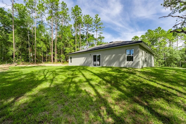 104 W Gondolier Pl, Citrus Springs, FL 34434 - rear view of property with a yard and stucco siding