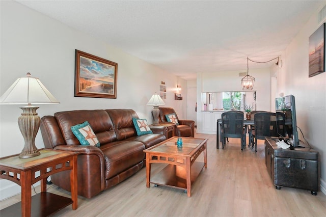 6218 Palma Del Mar Blvd S Unit 103, Saint Petersburg, FL 33715 - living area with light wood-type flooring and a chandelier