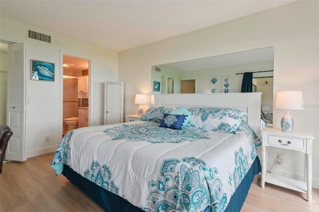 6218 Palma Del Mar Blvd S Unit 103, Saint Petersburg, FL 33715 - bedroom featuring wood finished floors, baseboards, and connected bathroom