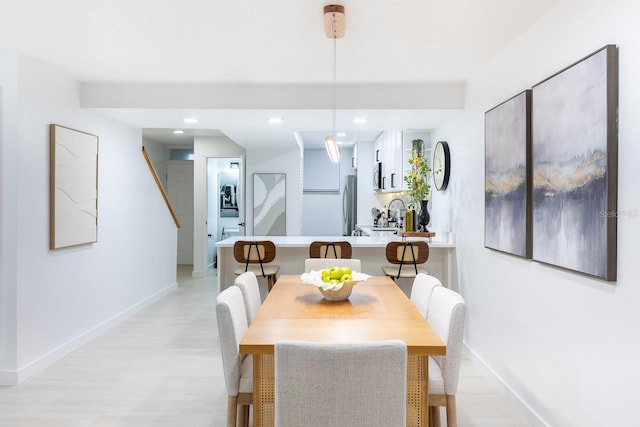 701 S Atlantic Ave Unit Ut21, New Smyrna Beach, FL 32169 - dining space with baseboards, light wood-style floors, recessed lighting, and stairs