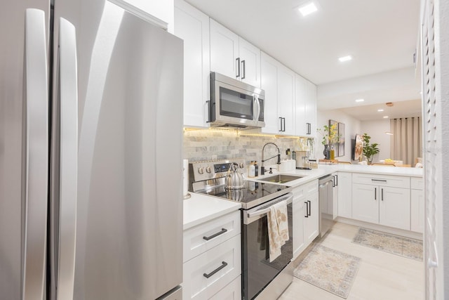 701 S Atlantic Ave Unit Ut21, New Smyrna Beach, FL 32169 - kitchen featuring stainless steel appliances, a sink, light countertops, backsplash, and white cabinets