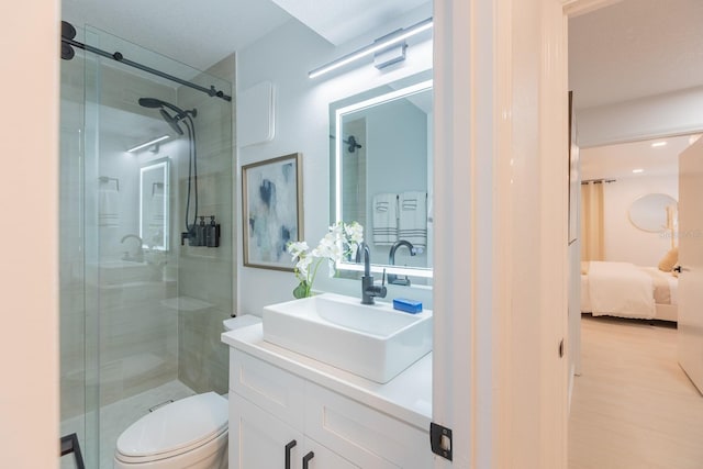701 S Atlantic Ave Unit Ut21, New Smyrna Beach, FL 32169 - full bathroom with vanity, a shower stall, ensuite bath, toilet, and wood finished floors