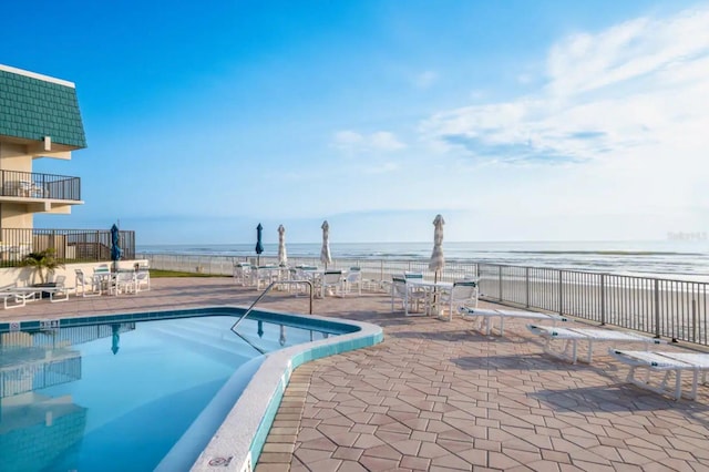 701 S Atlantic Ave Unit Ut21, New Smyrna Beach, FL 32169 - community pool with view of water and beach and a patio