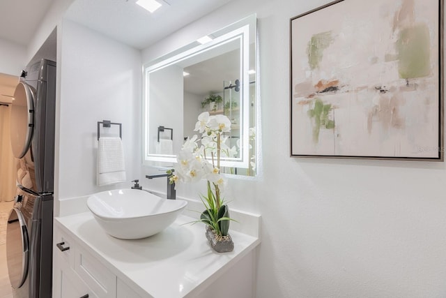 701 S Atlantic Ave Unit Ut21, New Smyrna Beach, FL 32169 - bathroom with stacked washing machine and dryer and vanity