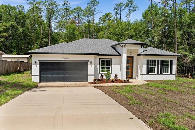 10290 N Biscayne Dr, Citrus Springs, FL 34434 - prairie-style house with stucco siding, an attached garage, concrete driveway, and a shingled roof