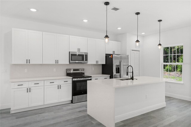 10290 N Biscayne Dr, Citrus Springs, FL 34434 - kitchen featuring stainless steel appliances, white cabinetry, light wood finished floors, and recessed lighting