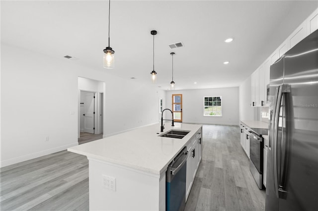 10290 N Biscayne Dr, Citrus Springs, FL 34434 - kitchen featuring stainless steel appliances, light wood-type flooring, white cabinets, open floor plan, and recessed lighting