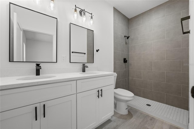 10290 N Biscayne Dr, Citrus Springs, FL 34434 - bathroom with double vanity, a tile shower, and wood finished floors