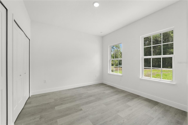 10290 N Biscayne Dr, Citrus Springs, FL 34434 - unfurnished bedroom with light wood-style floors and a closet