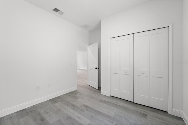 10290 N Biscayne Dr, Citrus Springs, FL 34434 - unfurnished bedroom with light wood-type flooring and a closet