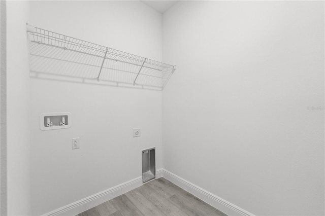 10290 N Biscayne Dr, Citrus Springs, FL 34434 - laundry room featuring electric dryer hookup, light wood-style floors, and hookup for a washing machine