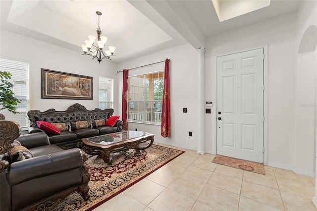 13768 Bluebird Pond Rd, Windermere, FL 34786 - living room with a chandelier, a raised ceiling, light tile patterned floors, and baseboards