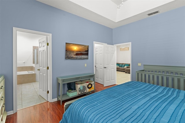 13768 Bluebird Pond Rd, Windermere, FL 34786 - bedroom featuring wood finished floors, baseboards, and ensuite bathroom