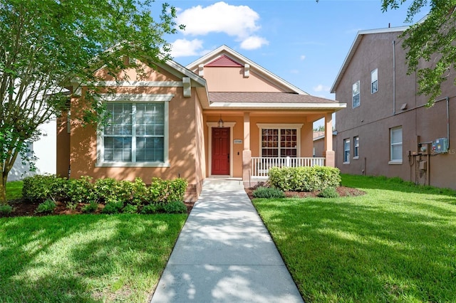 13768 Bluebird Pond Rd, Windermere, FL 34786 - view of front of property with a porch, stucco siding, and a front yard