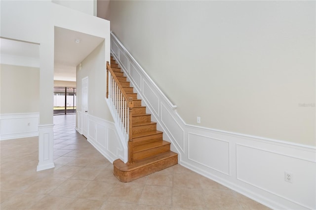 13519 Bicton Ln, Windermere, FL 34786 - staircase with a decorative wall, tile patterned flooring, and wainscoting