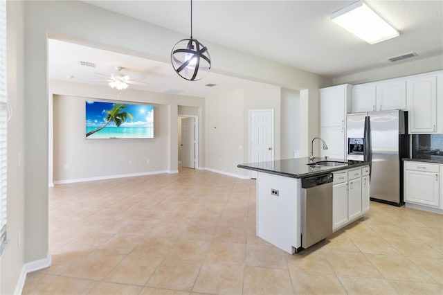13519 Bicton Ln, Windermere, FL 34786 - kitchen with stainless steel appliances, dark countertops, open floor plan, and light tile patterned floors