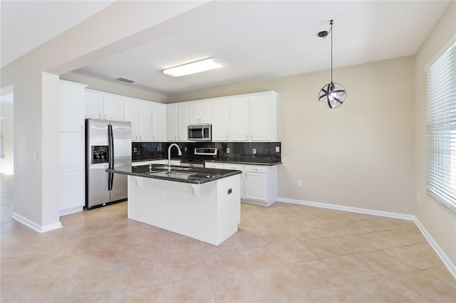13519 Bicton Ln, Windermere, FL 34786 - kitchen featuring stainless steel appliances, backsplash, white cabinetry, and a kitchen bar