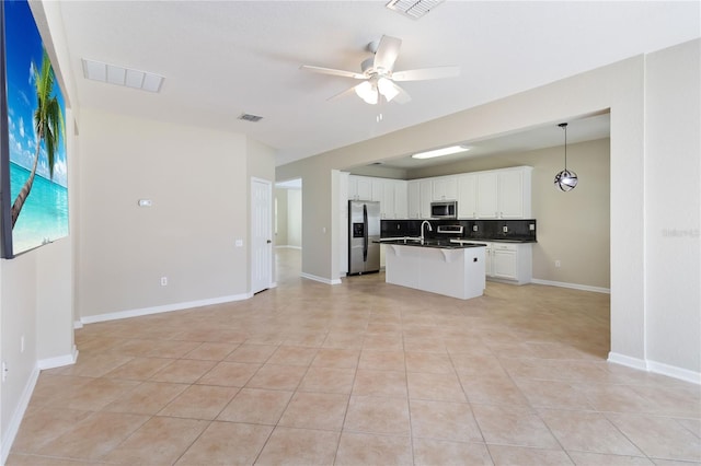 13519 Bicton Ln, Windermere, FL 34786 - kitchen with stainless steel appliances, open floor plan, a ceiling fan, decorative backsplash, and dark countertops