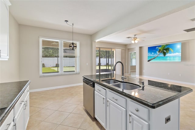13519 Bicton Ln, Windermere, FL 34786 - kitchen with stainless steel dishwasher, an island with sink, light tile patterned floors, white cabinetry, and decorative light fixtures