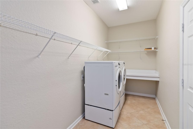 13519 Bicton Ln, Windermere, FL 34786 - washroom with washer and dryer and light tile patterned flooring