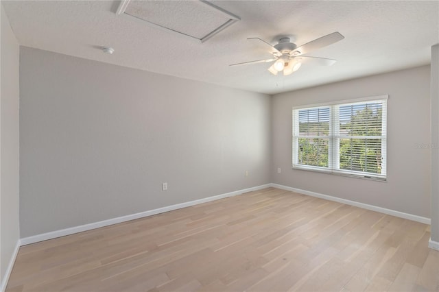 13519 Bicton Ln, Windermere, FL 34786 - empty room with attic access, light wood-type flooring, a textured ceiling, a ceiling fan, and a smoke detector