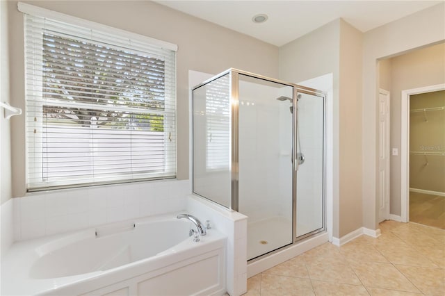 13519 Bicton Ln, Windermere, FL 34786 - bathroom featuring a garden tub, a shower stall, a spacious closet, and tile patterned floors