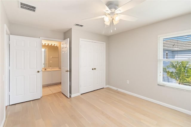 13519 Bicton Ln, Windermere, FL 34786 - unfurnished bedroom with light wood finished floors, a closet, ensuite bathroom, and ceiling fan