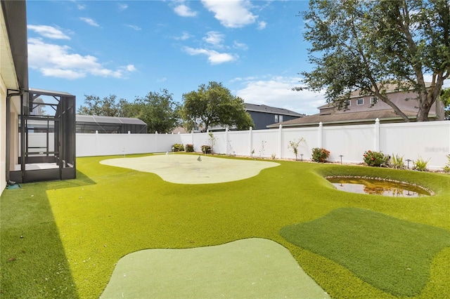 13519 Bicton Ln, Windermere, FL 34786 - fenced backyard featuring a putting green and glass enclosure