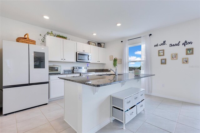 1854 Juneberry St, Clermont, FL 34715 - kitchen featuring appliances with stainless steel finishes, white cabinetry, light tile patterned floors, and recessed lighting
